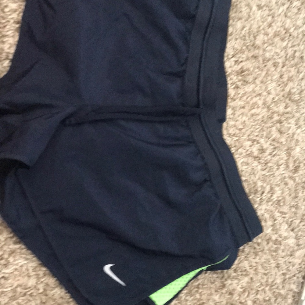 Blue and green accented Nike running shorts